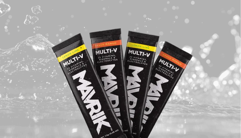 A fan of MULTI-V stick packs rising over dark splashing water